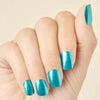 Hand with transformative teal chrome LED gel nail strips, curled inward to show the shine and coverage.