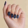 Magnetic dark navy blue LED gel strips on nails with beige background