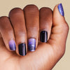 Hand with purple and black gradient Halloween bat nail art on LED gel strips