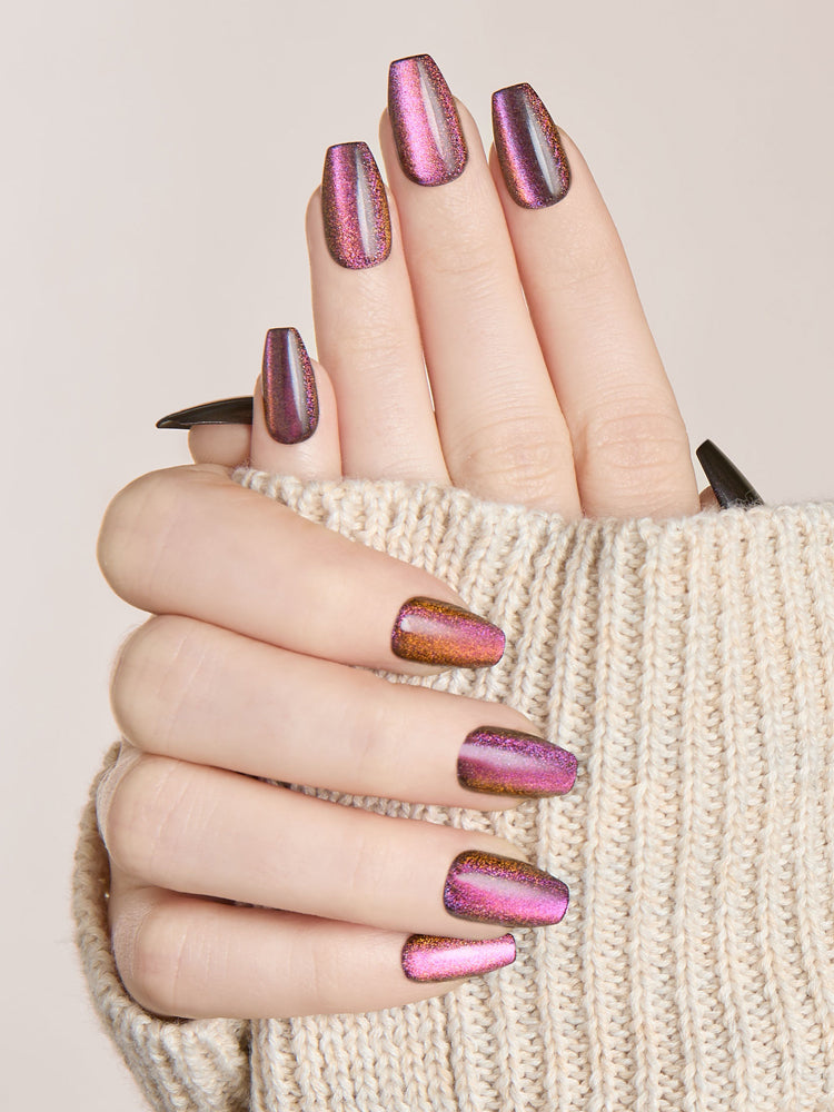 Hand wearing magnetic multichrome press-on coffin nails in pink and purple