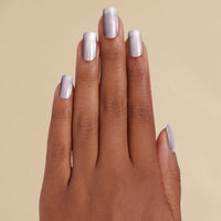 Hand with silver metallic LED gel strips on beige background