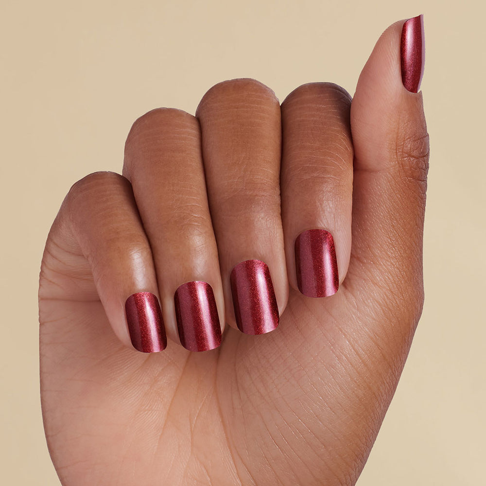 Hand with deep red magnetic LED gel strips on a beige background