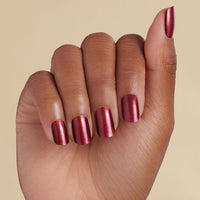 Hand with deep red magnetic LED gel strips on a beige background
