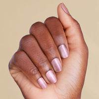 Hand with rose gold pink magnetic LED gel strips on beige background