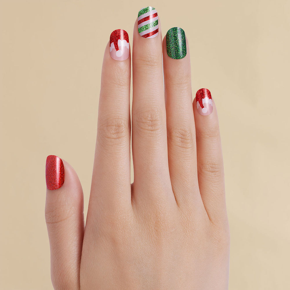 Hand with Christmas Santa red and green inspired LED gel strips on beige background
