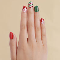 Hand with Christmas Santa red and green inspired LED gel strips on beige background