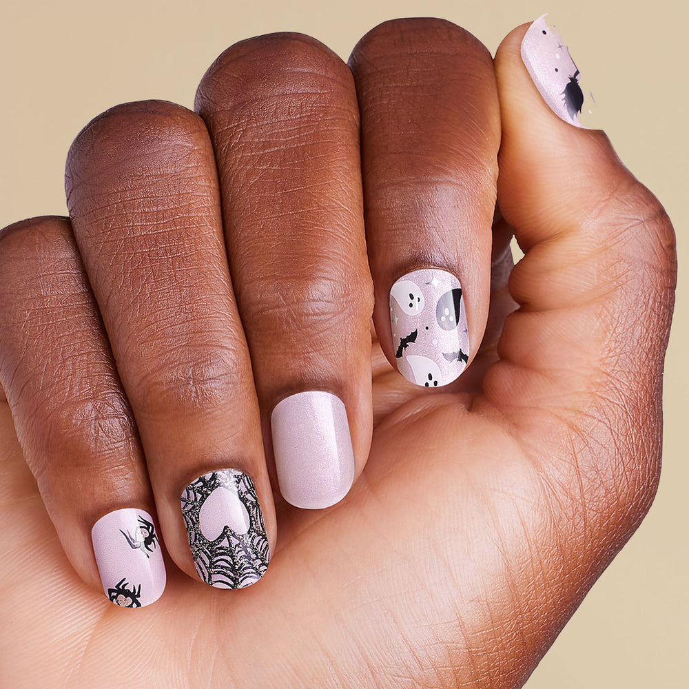 Hand with pink nails featuring black and pink nail art on LED gel strips