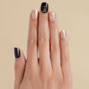 Hand with black and gold glitter snowflake LED gel strip nails