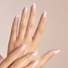 Close-up of a hand with ombre press on nails with red pink lip prints on a beige background