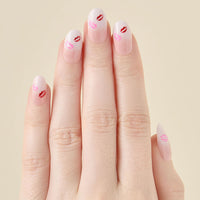 Hand with ombre press on nails and red lip print on a beige background