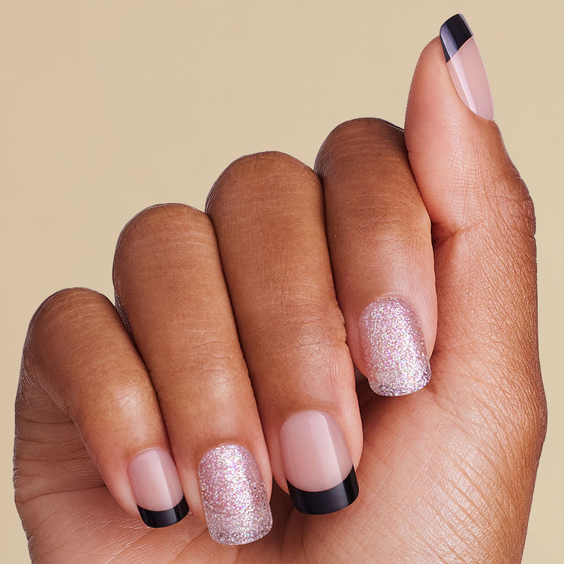 Hand with pink glittery and black french square press on nails