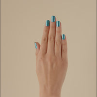 Video of a hand wearing transformative teal chrome LED gel nail strips, moving to show the reflective finish.