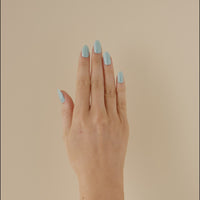  Hand with teal turquoise glitter LED gel nail strips, moving to show the sparkle